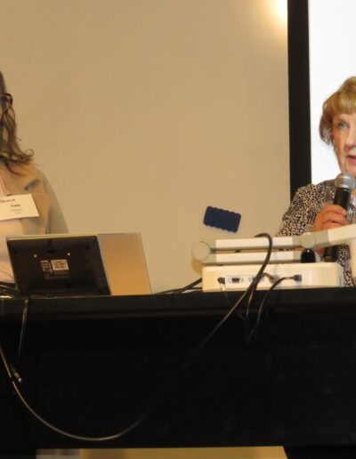 Sara Giboney and Sherry Thompson announcing high school contest winners